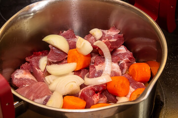 Beef stew in Burgundy. With carrots, onions, peas and champignons in wine. View from above