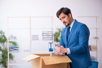 Young male employee in business relocation concept