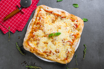 margarita pizza at the Rome dough with basil,pinsa, on grey table top view