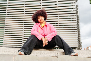 portrait of an african american woman looking into the camera with curly hair. curvy woman posing