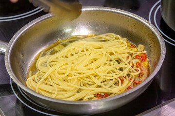 Vegetarian Italian Pasta Spaghetti Aglio E Olio with garlic bread, red chili flake, parsley, parmesan cheese.