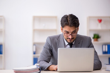 Young male employee working in the office