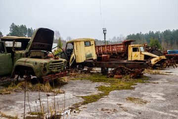 Old rusty abandoned damaged trucks in Chernobyl exclusion zone, Ukraine