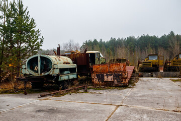 Fototapeta na wymiar Old rusty abandoned damaged trucks in Chernobyl exclusion zone, Ukraine