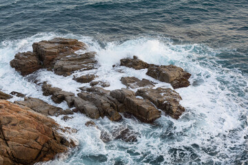 Rocks and cliffs on the Costa Brava in the Mediterranean Sea in northern Catalonia, Spain.