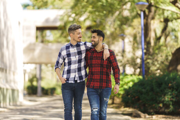 Obraz premium gay couple walking around hugging and looking at each other