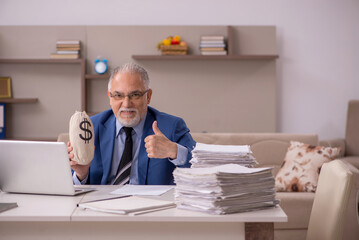 Old male boss working from home in remuneration concept