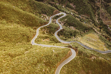 The winding road through the green mountain park.
