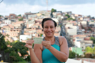 salvador, bahia, brazil - may 8, 2022: woman holding voter registration during electoral period in...