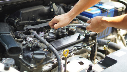 Check the engine system, professional technicians, working, checking the condition of the car, repairing the damaged engine.   