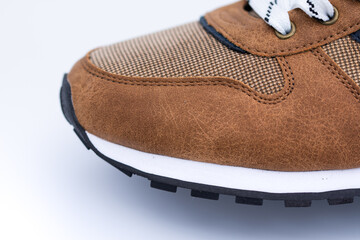 brown sneakers with fine stitching and perforated design