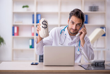 Young male doctor working in the clinic