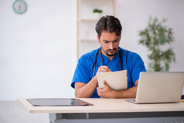 Young male doctor working in the clinic