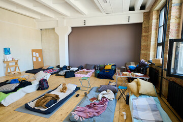 Several sleeping places consisting of mattresses, blankets and pillows prepared for temporarily...