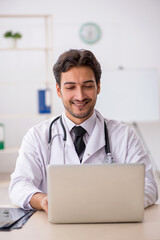 Young male doctor in telemedicine concept