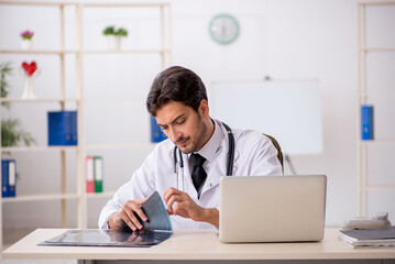 Young male doctor radiologist working in the clinic