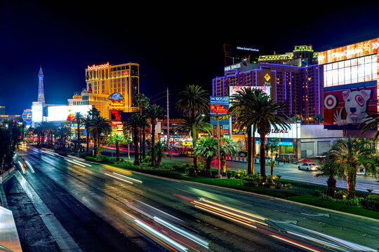Las Vegas Strip at night. Street view, hotels, traffic, city life. Paris, and Planet Hollywood Hotel and Casino. Classic Vegas style at the center of the Strip.