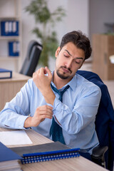 Young male employee working in the office