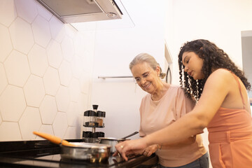 Mãe aprendendo a cozinhar com a vovó