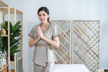 Portrait of Asian young masseuse woman smiling and looking at camera.  - obrazy, fototapety, plakaty