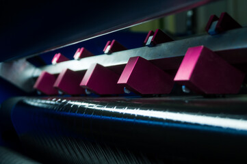 Thermal Transfer Ribbon Slitting and Rewinding Machine. Film cutting unit. A group of blades of a working machine for cutting ribbons. Selective focus