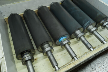Used printing shafts for flexographic printing press. A set of rubberized knurling shafts in a...