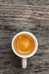 Top view of espresso cup on wooden table background