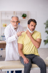 Fototapeta premium Young male neck injured patient visiting old male doctor