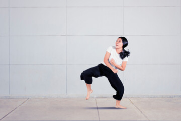 Young woman performing karate kick in studio