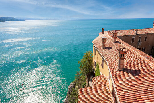View of the coast from Duino Castle on a cliff above the Gulf of Trieste (Adriatic Sea), Italy. Medieval tiled roof of the Duino fortress.