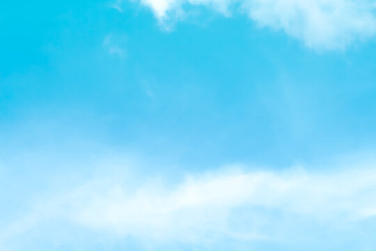Soft clouds on bright blue sky background and copy space
