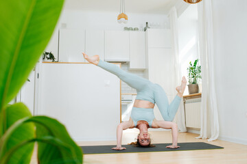 Fun time for a woman standing on her head in a complicated asana