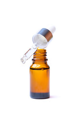 brown bottle with pipette and essential oil isolated on a white background
