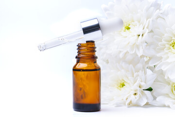 Essential oil and white chrysanthemum flowers