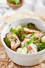 Healthy eating: steamed vegetables with salmon. Healthy salmon meal with broccoli and cauliflower. Casserole with fish and broccoli for lunch. Broccoli dish in diet menu. Cooked fish and veggies.