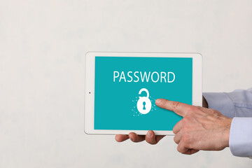 Male hands holding table computer with locked screen on light background