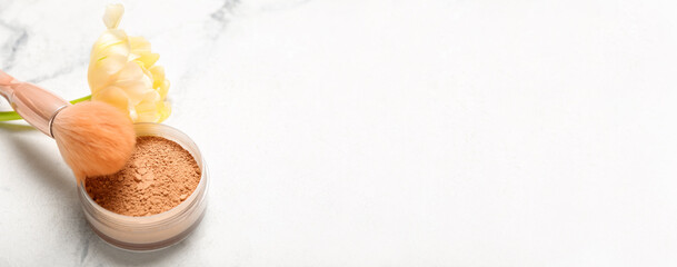 Makeup powder and brush with tulip flower on white background with space for text