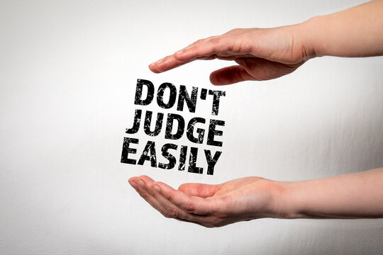 Do Not Judge Easily. Woman's hands and text on a white background