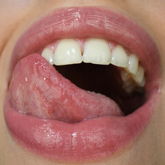 Obraz premium Sexy tongue. Sensual woman pursing her lips in a sexy seductive gesture.