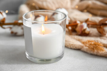 Holder with burning candle on table, closeup