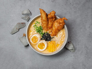 cheese ramen with chicken katsu on gray background