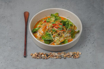 squid salad with vegetables and kimchi sauce on gray background