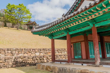 Obraz premium Landscape of public park and wooden oriental buildings with tiled roofs.