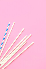 Stylish straws for drinks on pink background