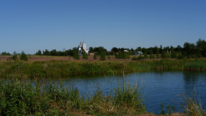 Summer day rural pond or overgrown lake