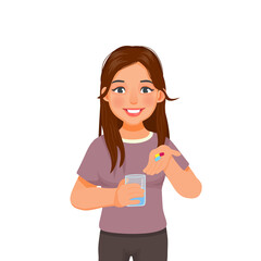 Beautiful young woman showing pills on her hand ready taking medicine with a glass of water