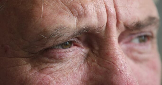 Close up cropped view older serious man staring into distance feels worried, recollect memories, deep on sad thoughts having melancholic mood. Life troubles, elderly age, vision care, eyesight concept