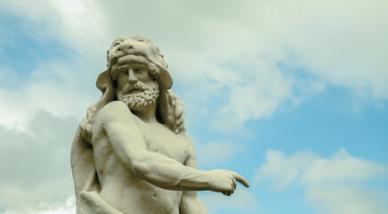 Fragment of an ancient stone statue of Hercules wearing Nemean lion skin. Copy space.