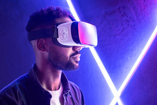 Young Stylish Man Using Virtual Reality Headset, VR, Future Gadgets, Technology, Virtual Event, Education, Learning, Video Game Concept, Portrait Of Modern Guy Using Vr Glasses Over Neon Background