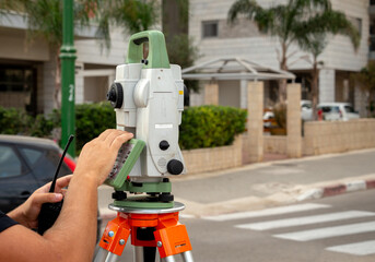 Surveyor's telescope at a construction site to draw up a layout of plans before starting construction work.